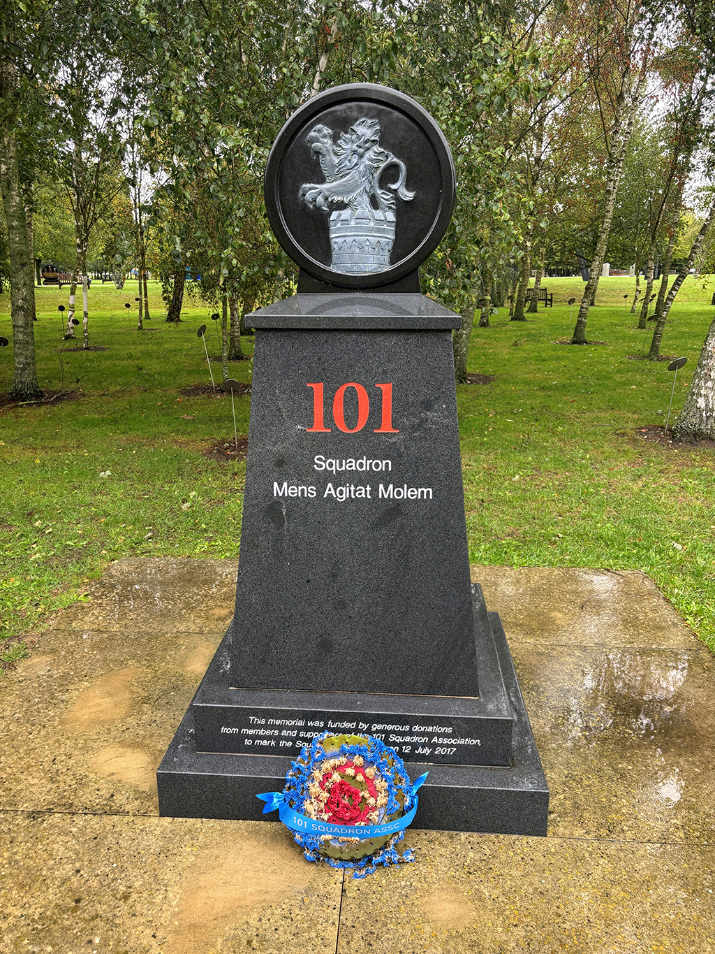 The Number 101 Squadron memorial, a pedestal with the words, '101 Squadron Mens Agitat Molem (Mind Over Matter). Atop the pedestal is circle stone embossed with the centre image of the Squadron badge.